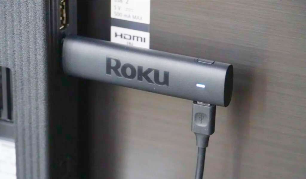 Roku Stick Device plugged into the HDMI port of a TV