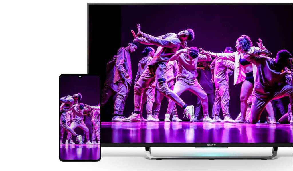 An Android smartphone and a smart TV displaying the same image of a dance performance