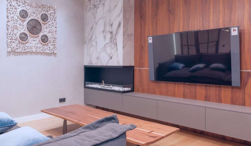 A wall-mounted samsung tv in a moder living room