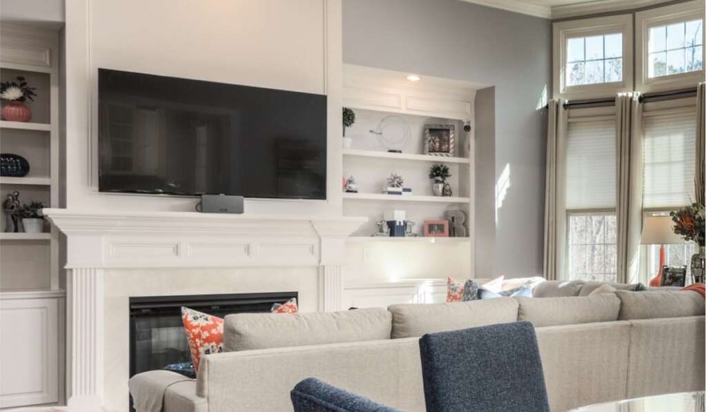 Wall-mounted samsung tv with a soundbar in a modern living room