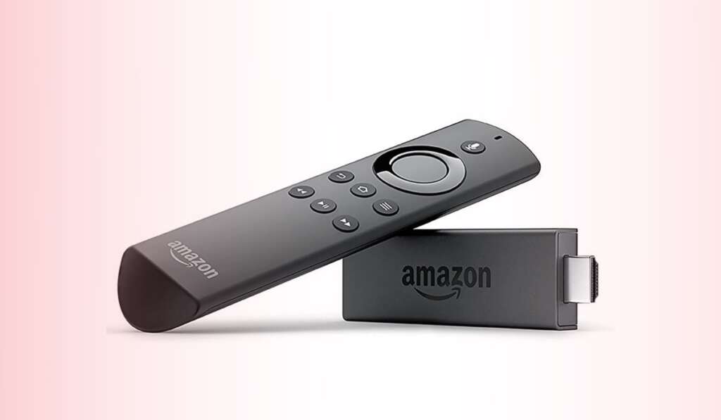Amazon Fire TV remote propped up against a Firestick device