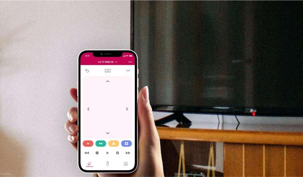 Hand holding an iphone with lg tv remote app. Black screen LG TV